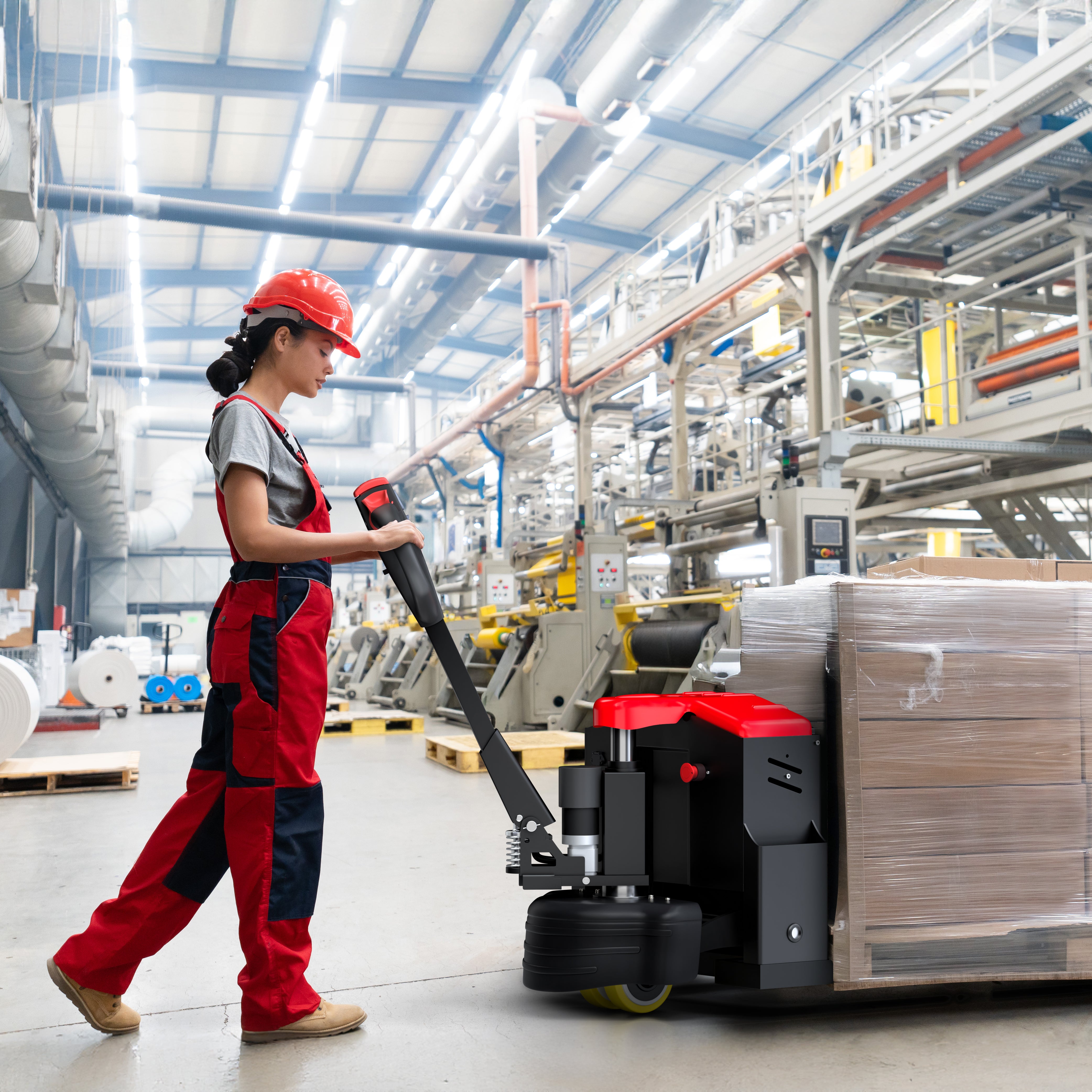 Person operating a pallet truck in a warehouse setting