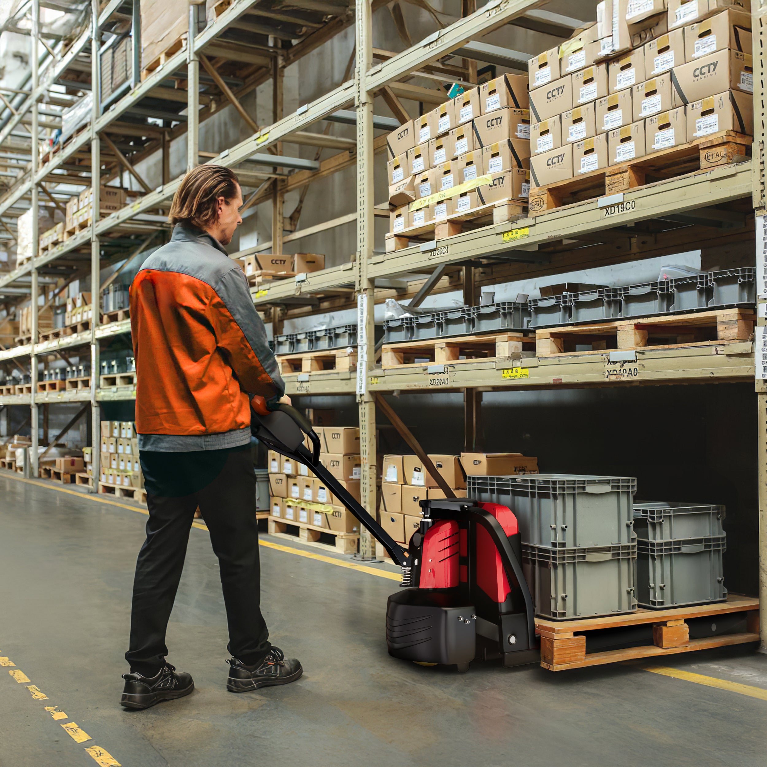 Person using a pallet jack in a warehouse with stacked boxes and crates.