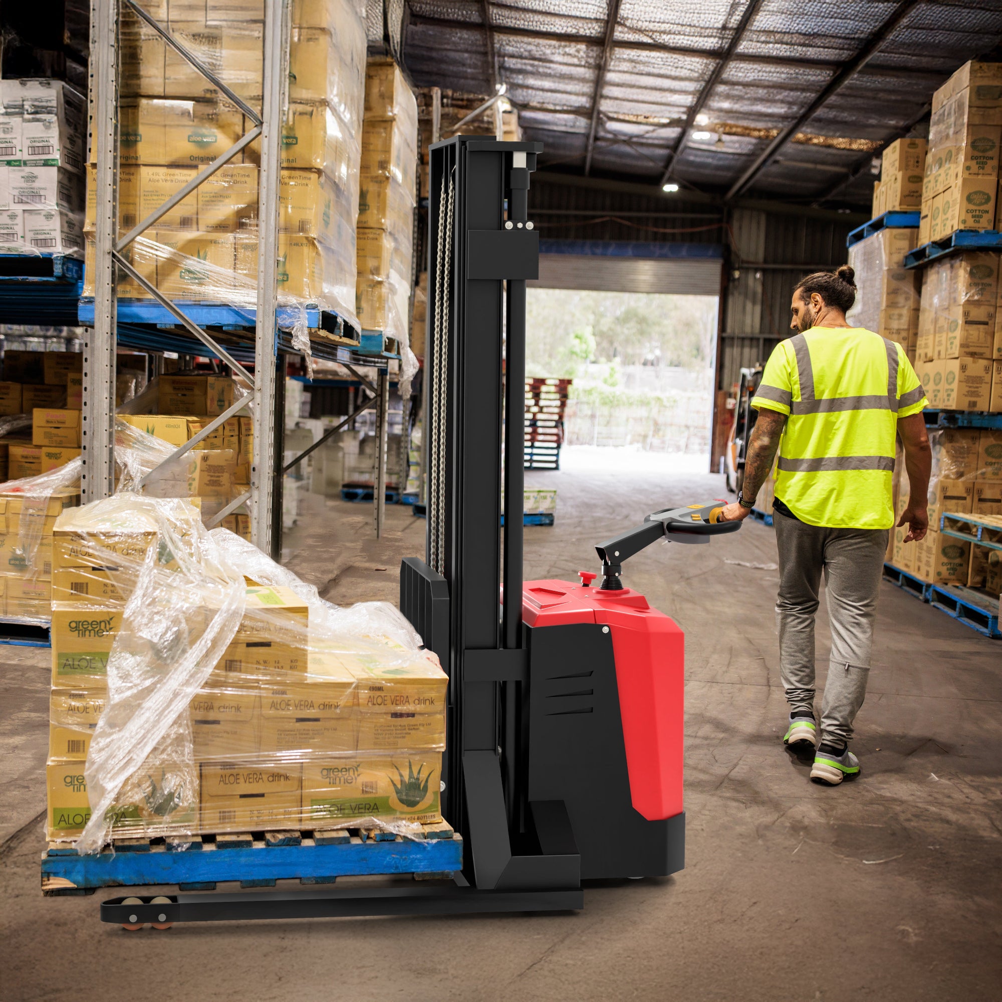 Person operating a forklift in a warehouse with stacked boxes.
