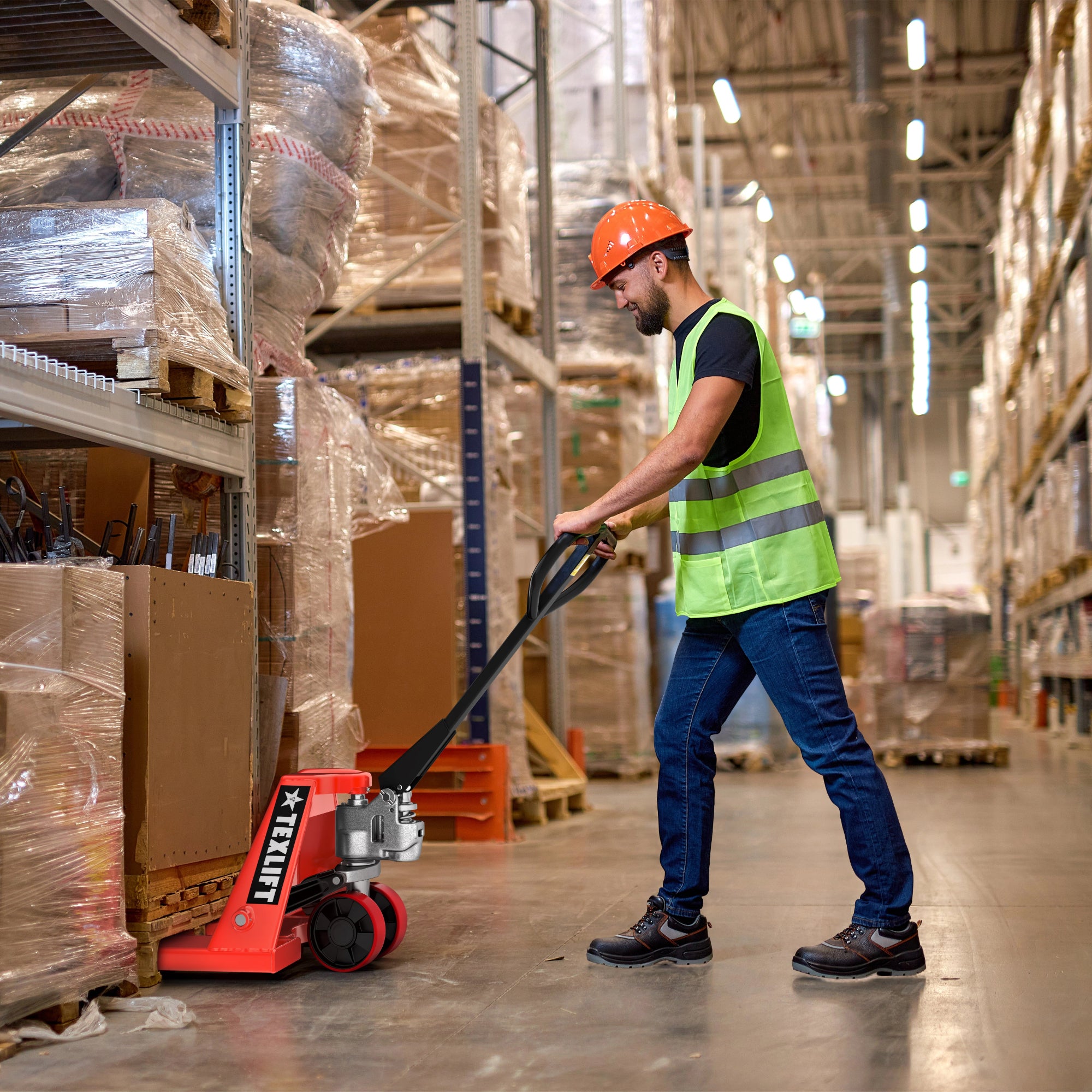 Worker operating a pallet jack in a warehouse